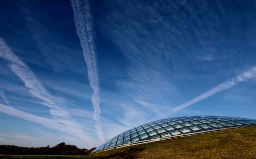 Great Glass House and cloudy blue skies